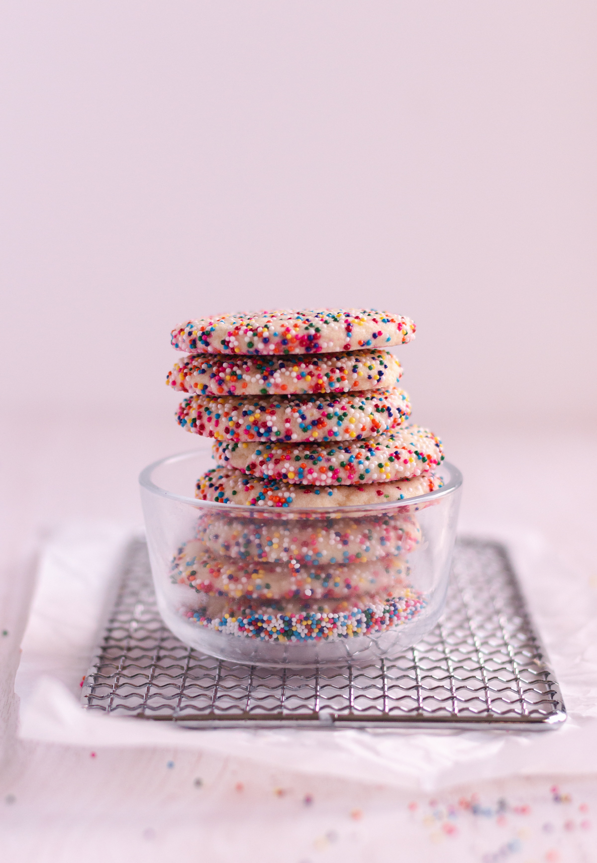 stacked sugar cookies coming out of a clear bowl