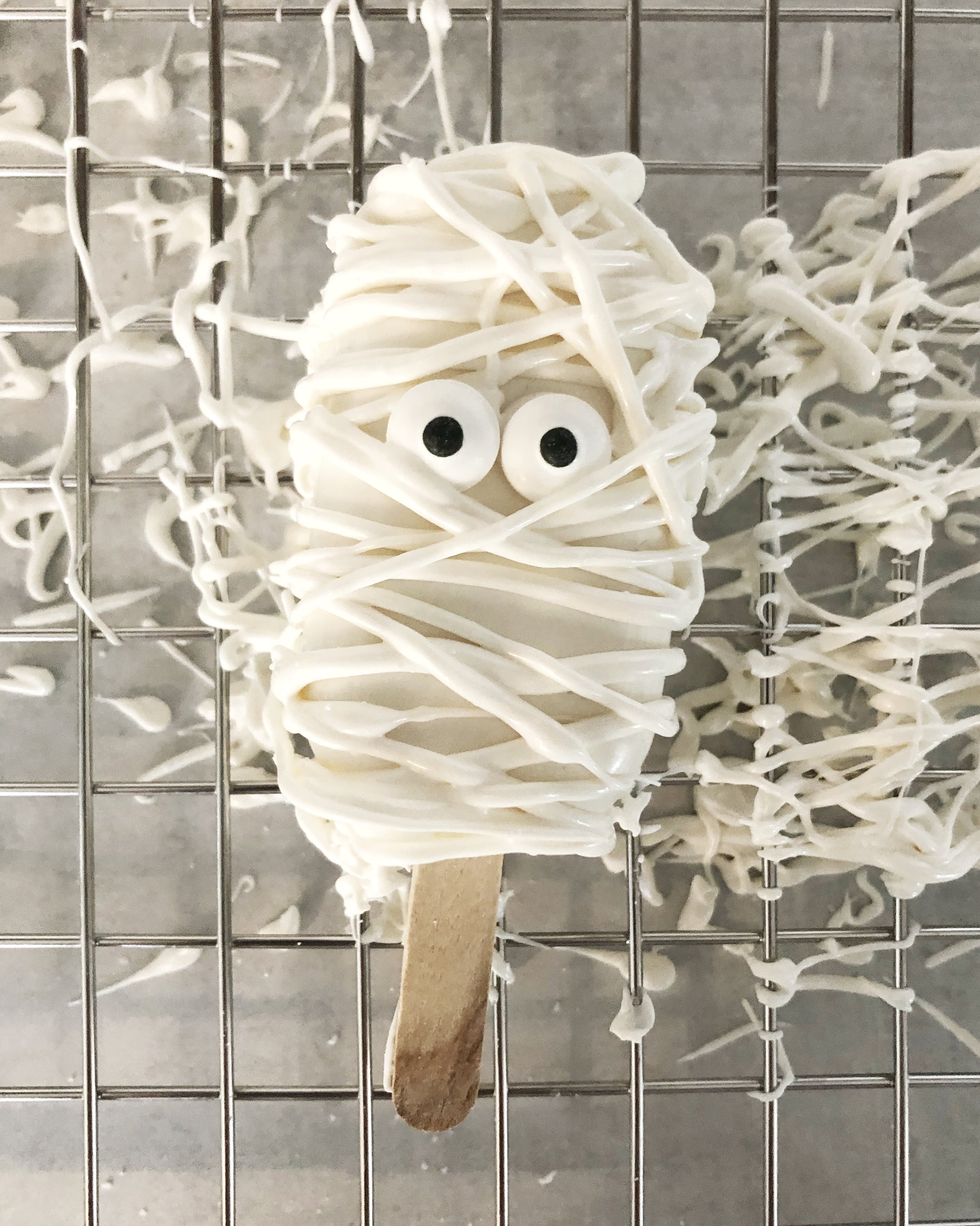 mummy cakesicle on a wire rack