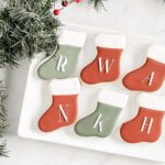 christmas stocking sugar cookies on a white plate