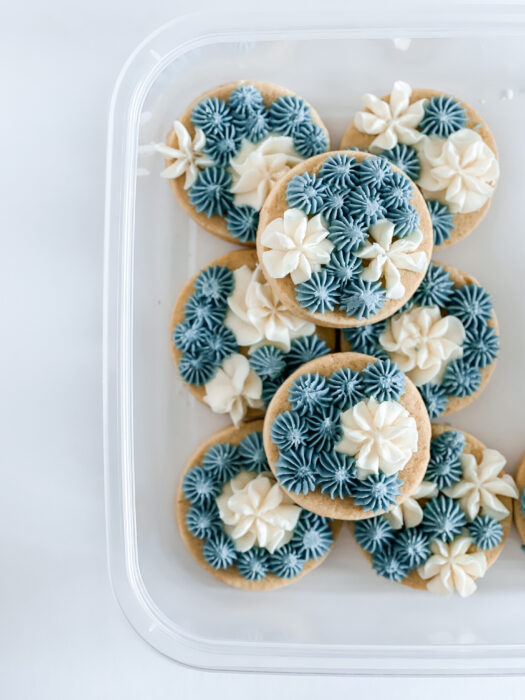 buttercream frosted cookies in tupperware