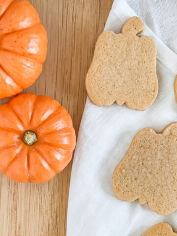 pumpkin flavored sugar cookies cut out in shape of pumpkins