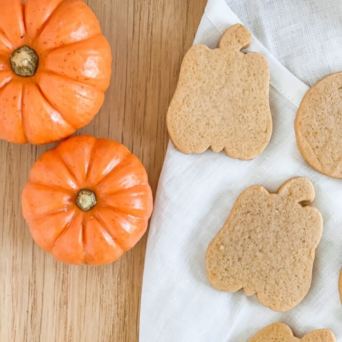 pumpkin flavored sugar cookies cut out in shape of pumpkins