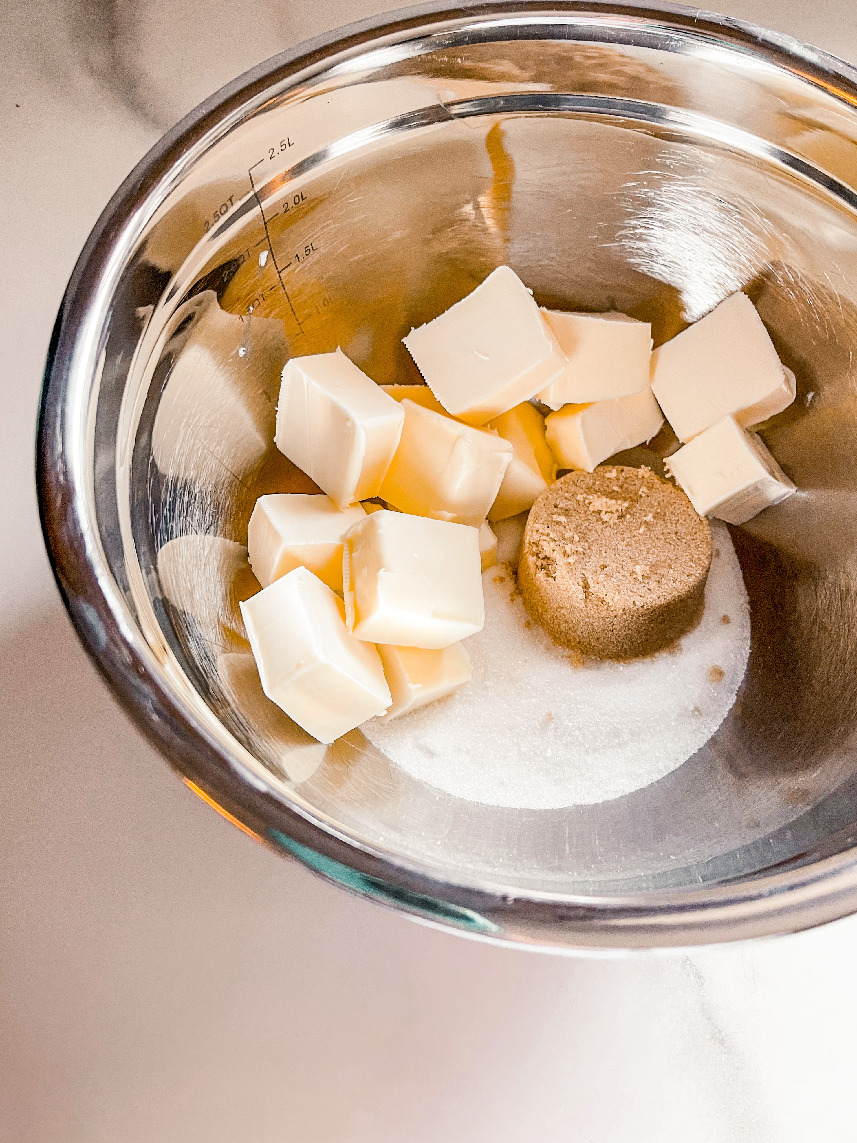 cubed butter in bowl with sugars