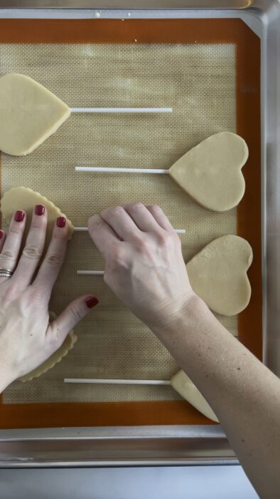 adding lollipop sticks to cookie dough pieces