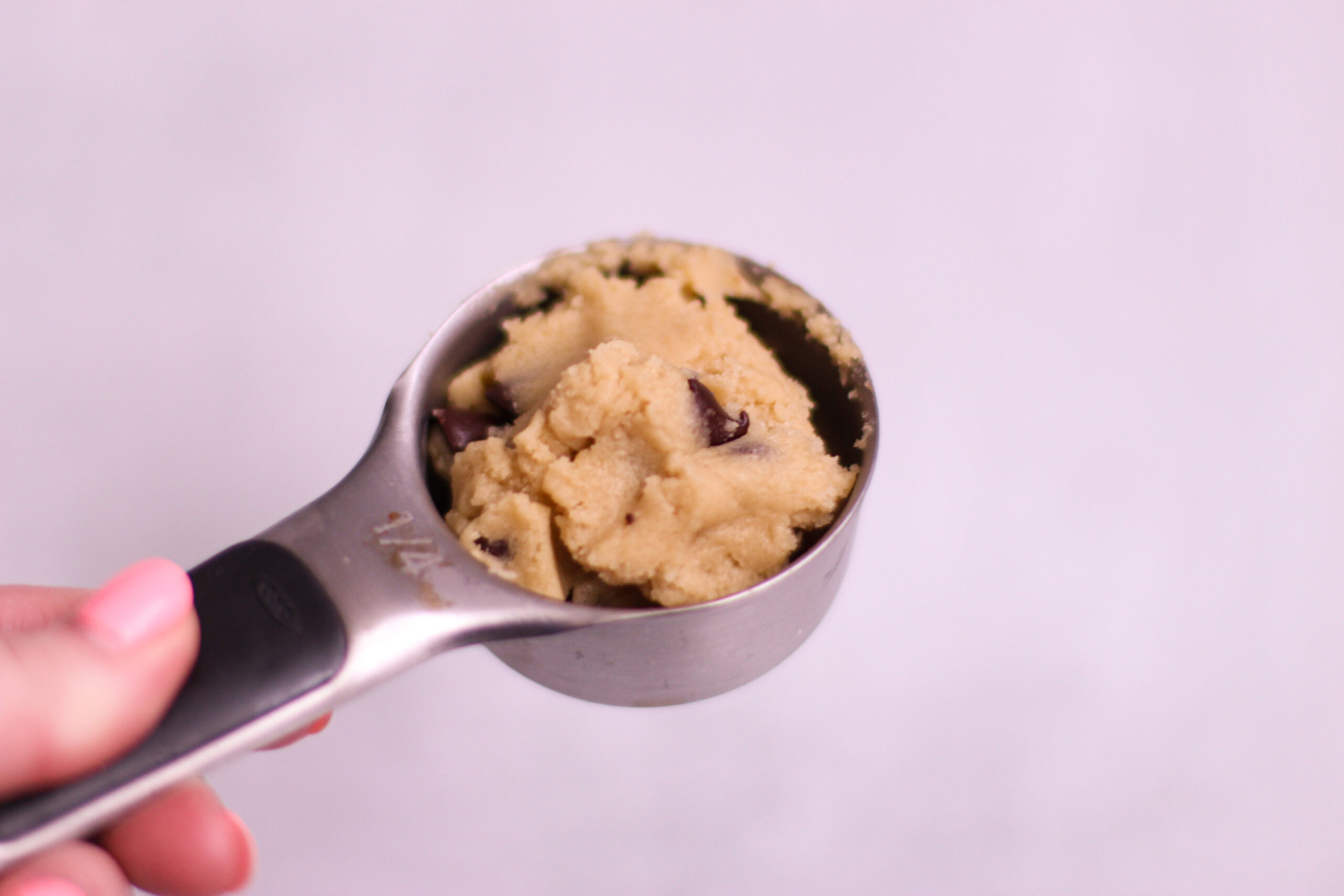 cookie dough in ¼ measuring cup