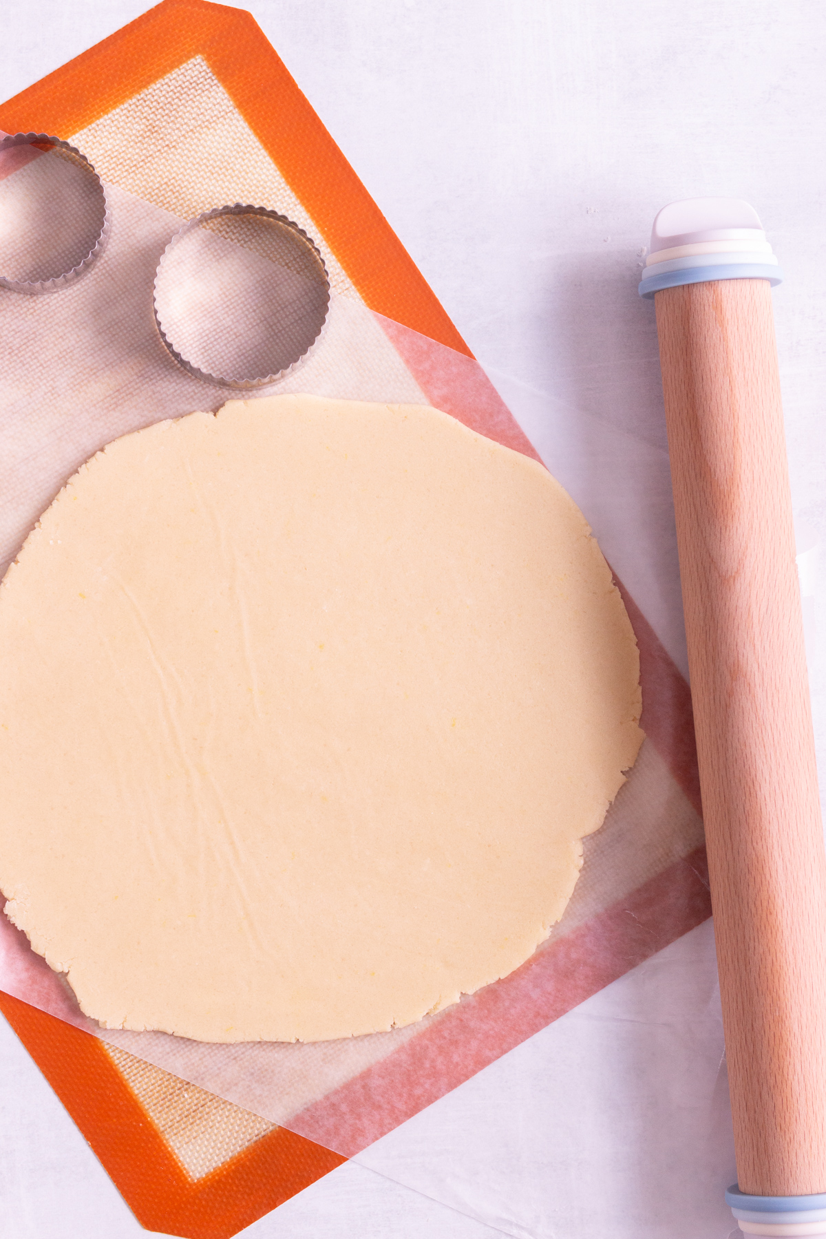 lemon sugar cookie dough rolled out onto wax paper