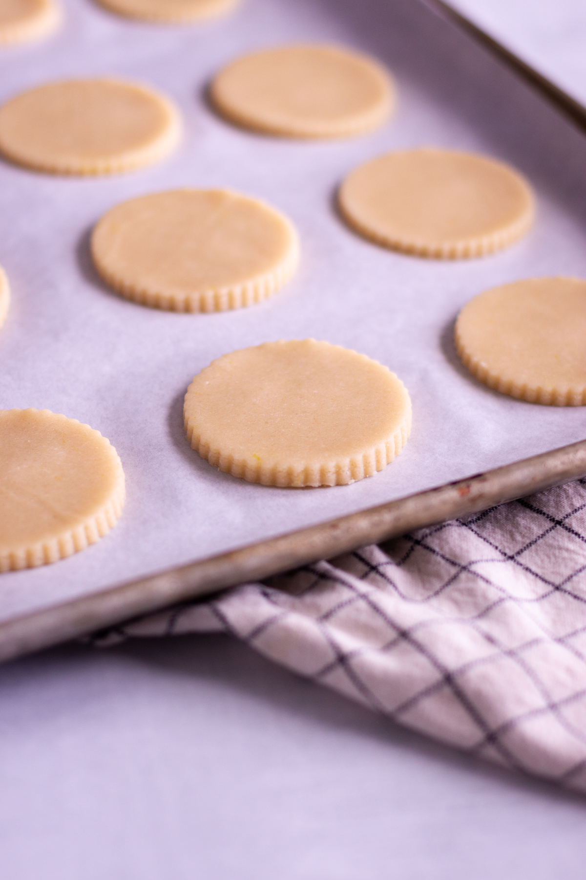 lemon sugar cookie cutouts, unbaked on cookie sheet