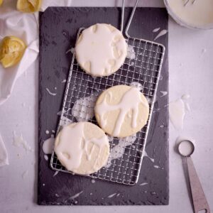 sugar cookies on wire rack coated with lemon glaze