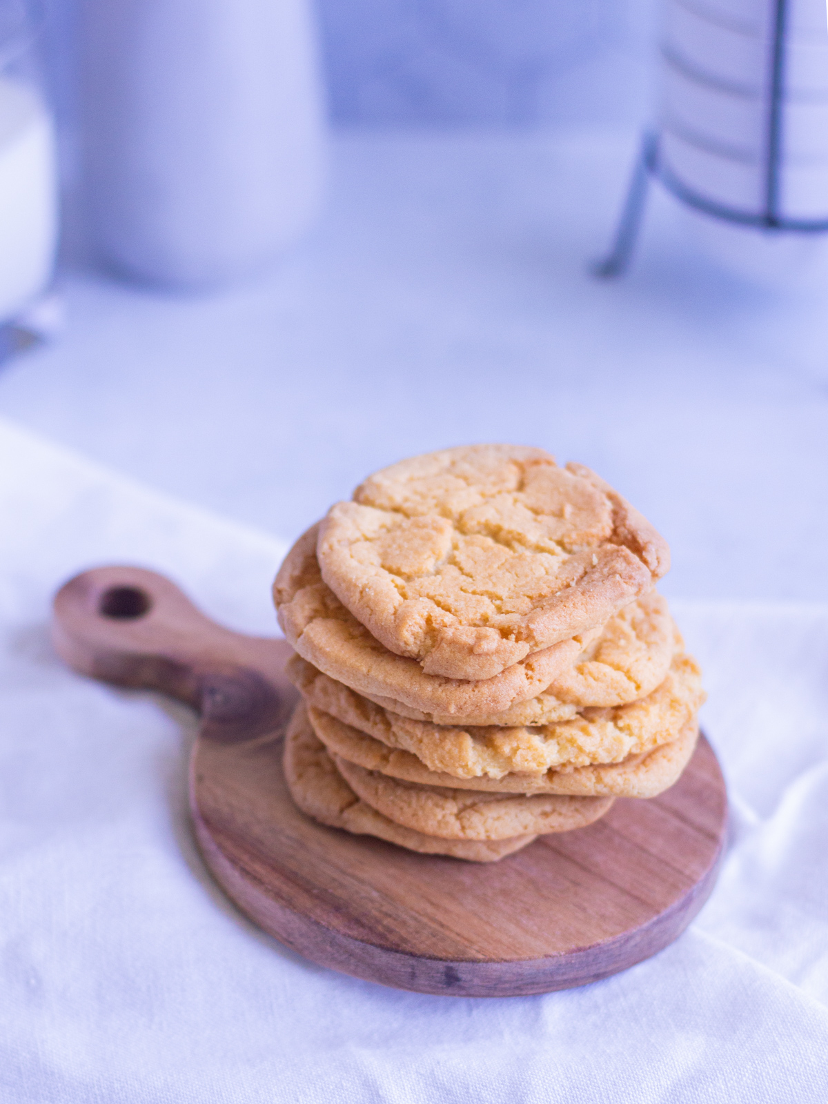 stack of sugar cookies on a small wooden serving platter