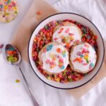 Fruity Pebble sugar cookies in a bowl of fruity pebble cereal