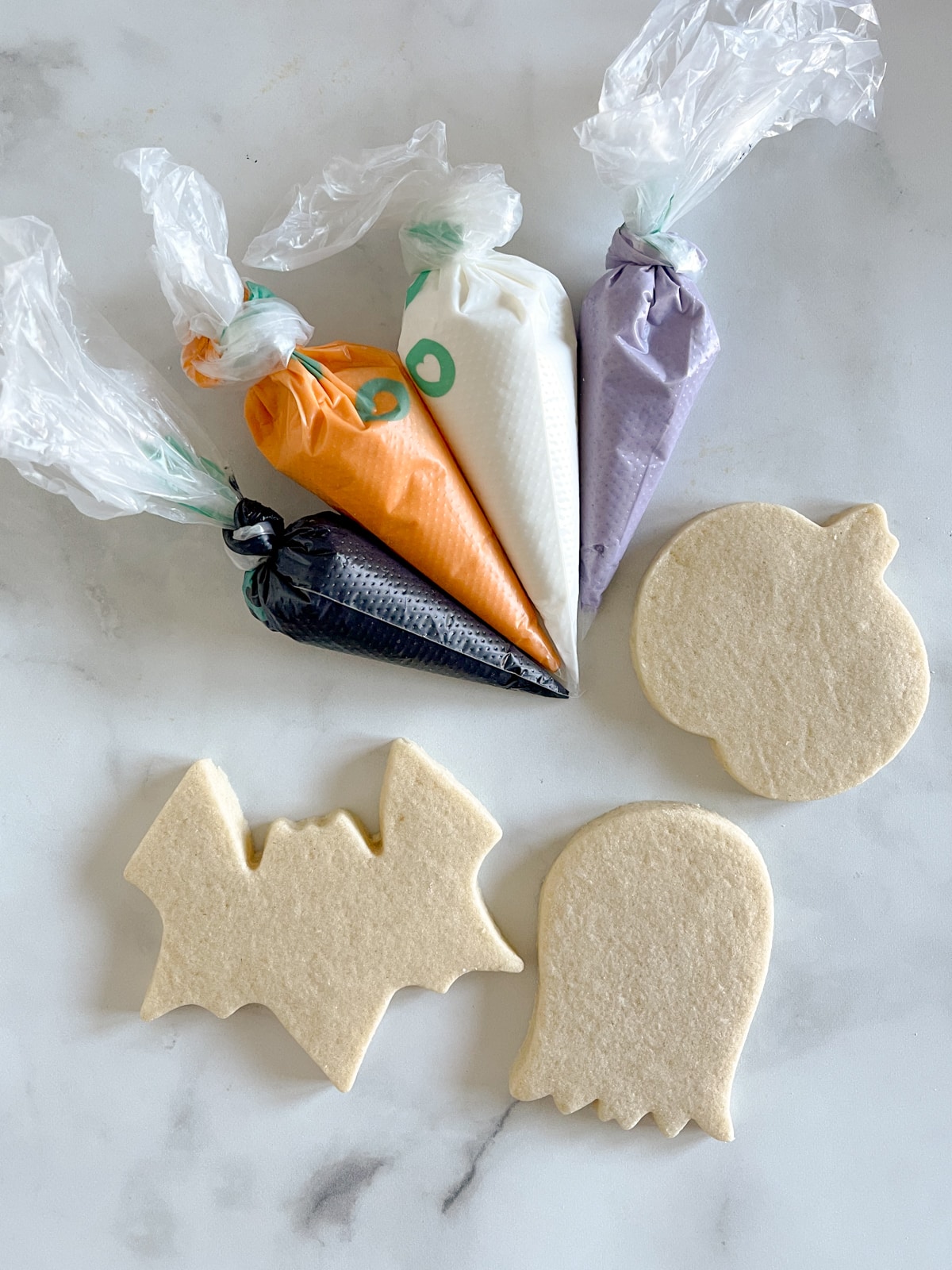 undecorated sugar cookies with royal icing bags