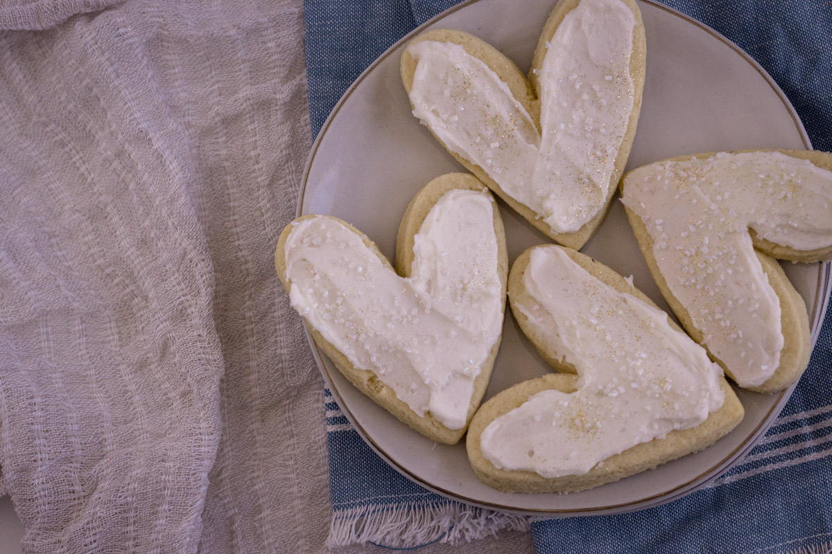 Frosted almond sugar cookies on a plate.