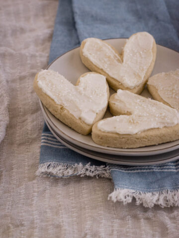 Frosted almond sugar cookies on a plate.