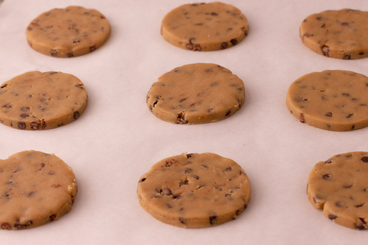 chocolate chip cookie dough cutouts on a baking sheet, unbaked 