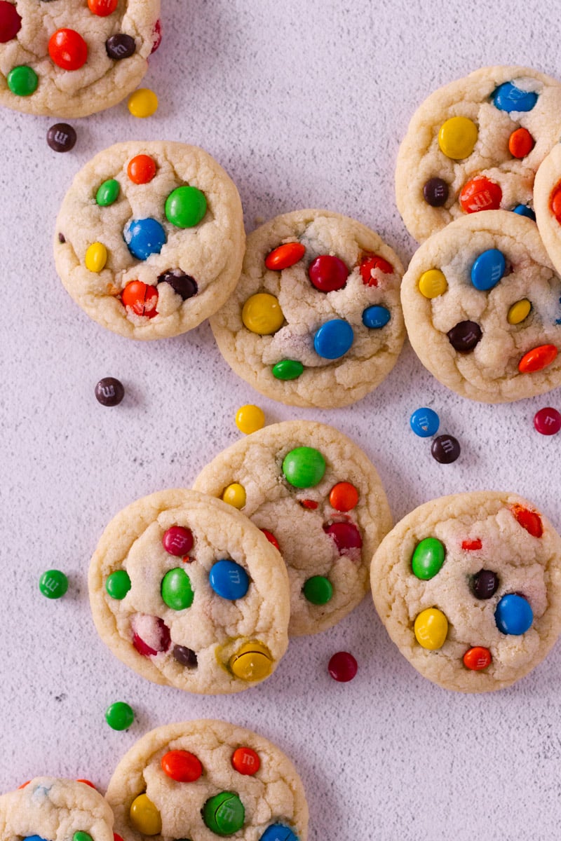 M&M Cookies spread out on a counter.