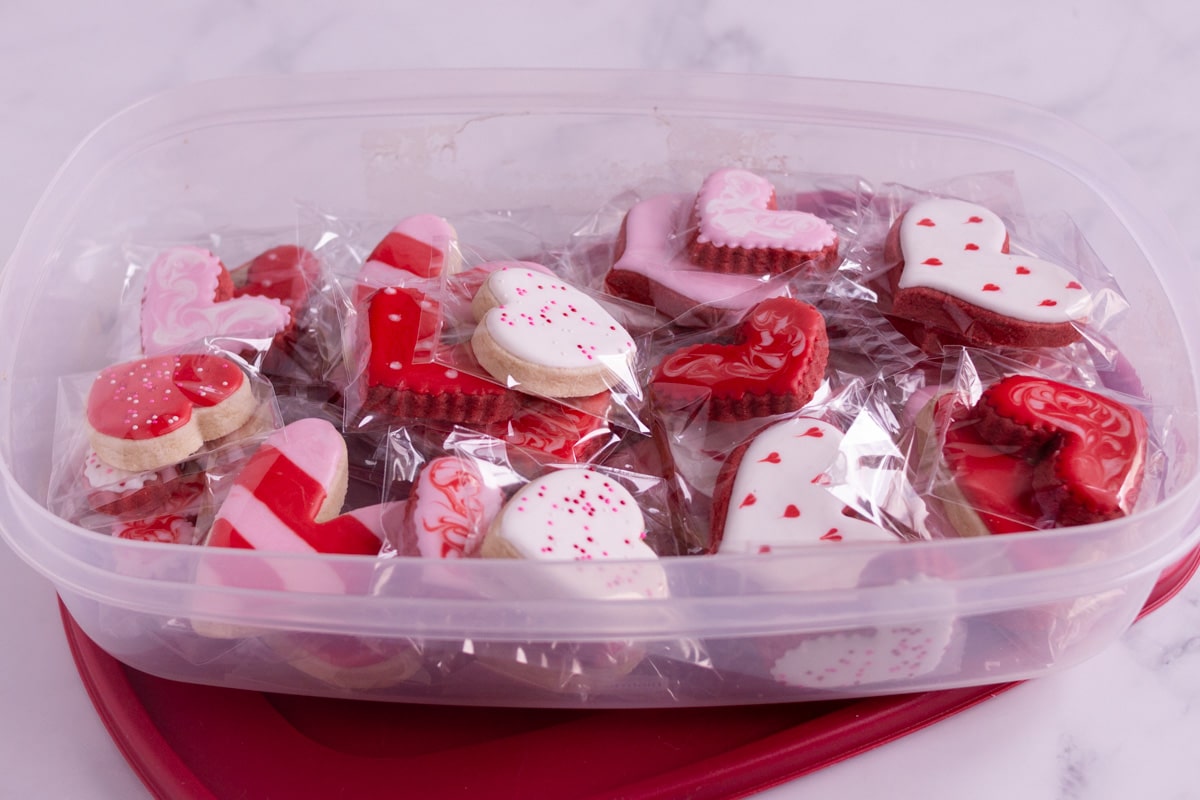 Royal icing cookies in a tupperware container. 