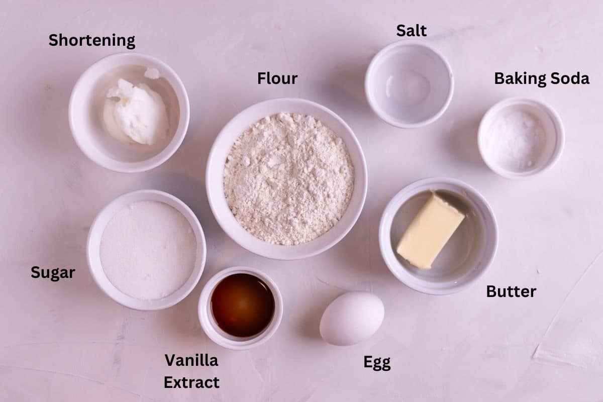 Ingredients for sugar cookies in small bowls.