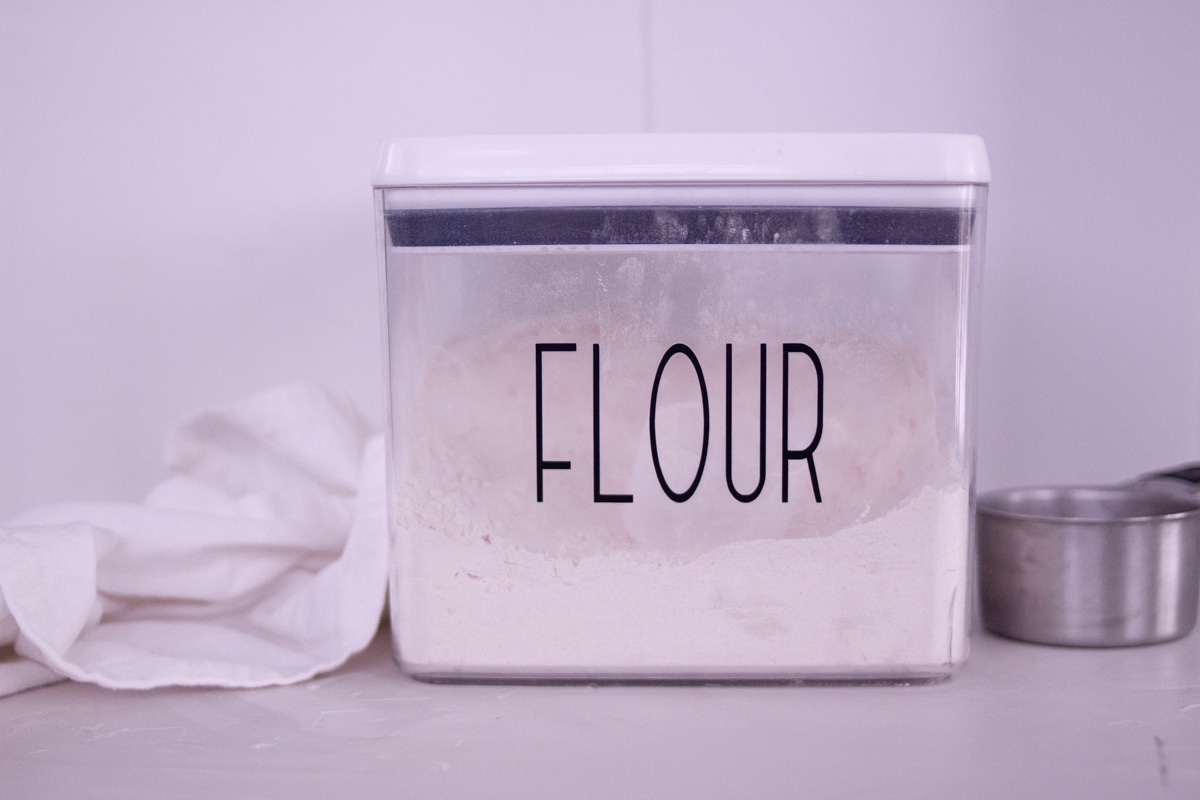 Flour in a clear plastic storage container.